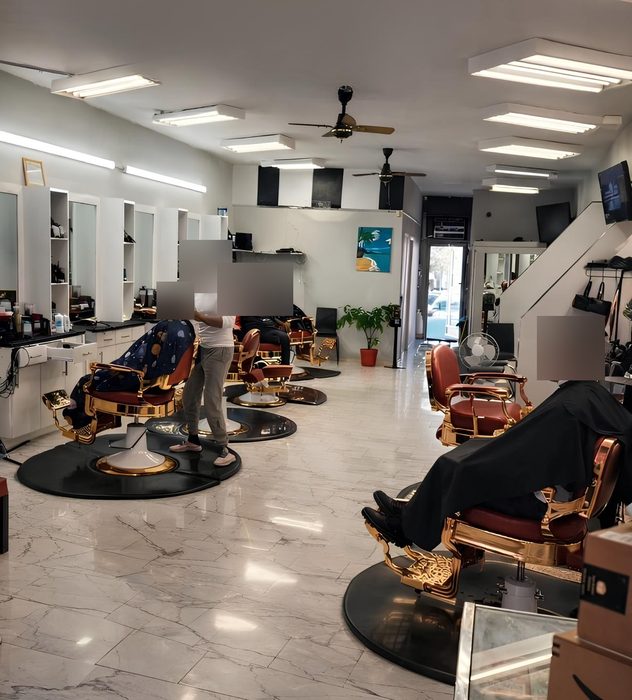Inside Elite: gold-and-red barber chairs