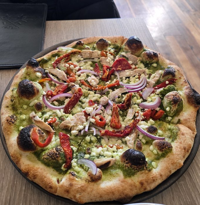 Pesto pizza with a charred crust